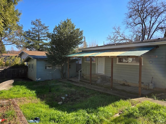 back of house featuring a lawn