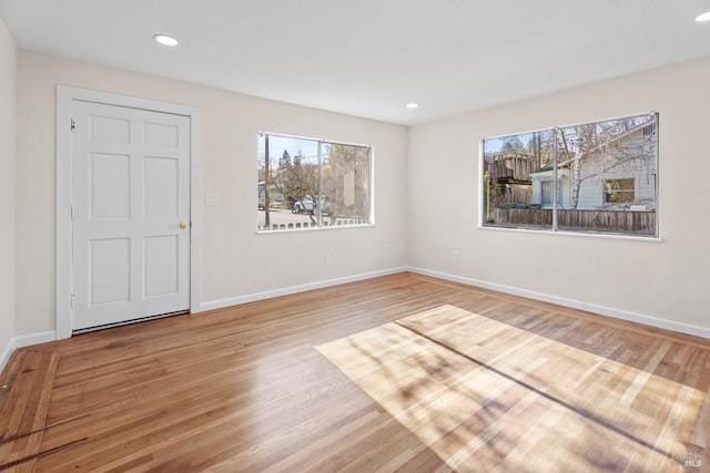 unfurnished room with hardwood / wood-style flooring