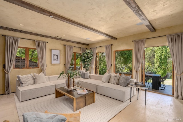 living room with beamed ceiling and a wealth of natural light