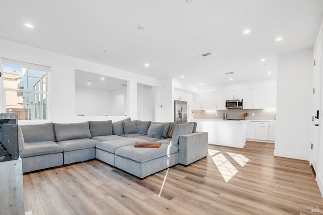 living room with light hardwood / wood-style flooring