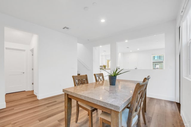 dining space with light hardwood / wood-style floors