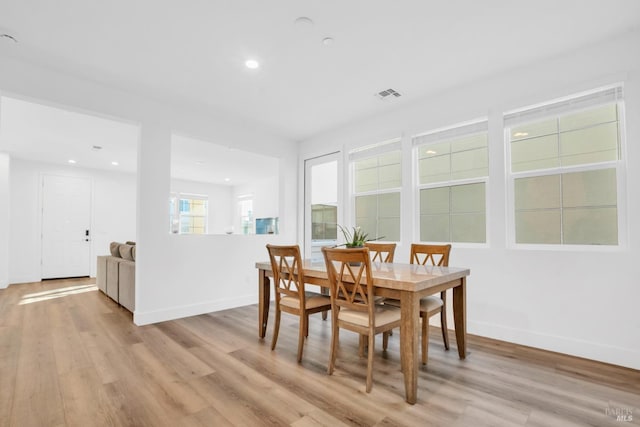 dining area featuring plenty of natural light and light hardwood / wood-style flooring