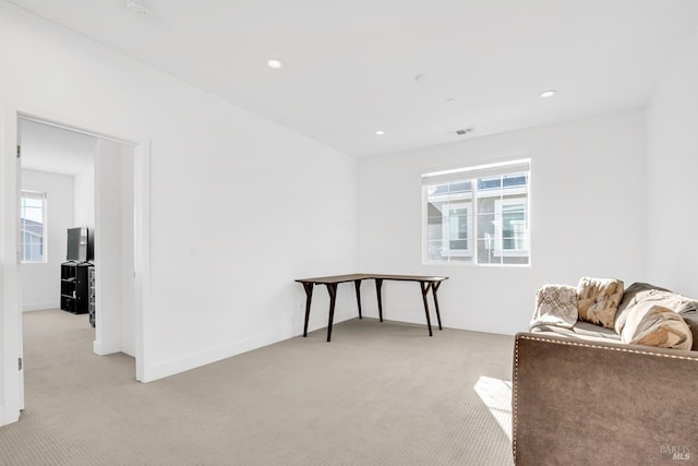 living area with light colored carpet