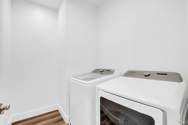 washroom featuring washer and clothes dryer and hardwood / wood-style flooring