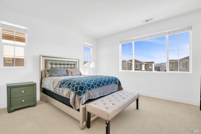 bedroom featuring light carpet