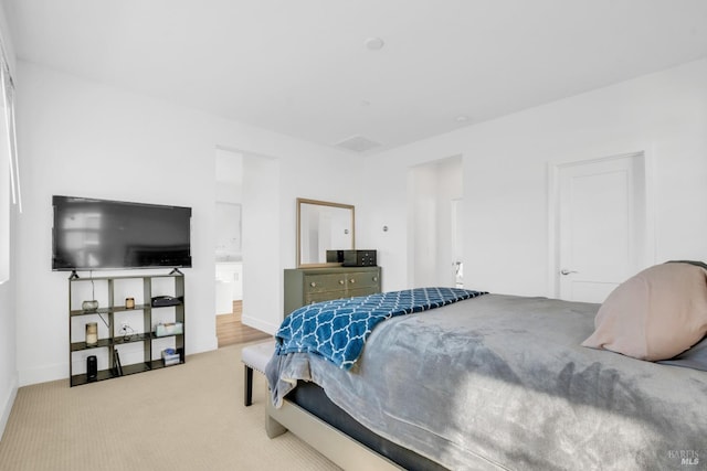 carpeted bedroom featuring connected bathroom