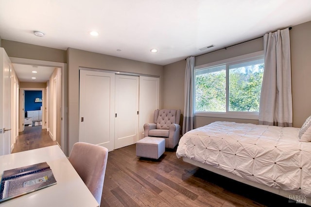 bedroom featuring dark hardwood / wood-style floors and a closet