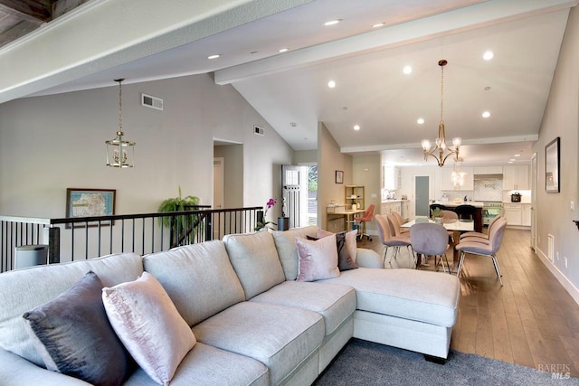 living room featuring beamed ceiling, wood-type flooring, high vaulted ceiling, and a chandelier