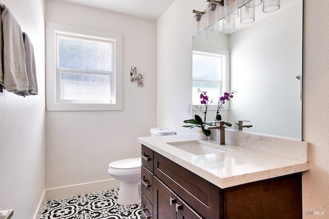 bathroom with vanity, tile patterned floors, and toilet