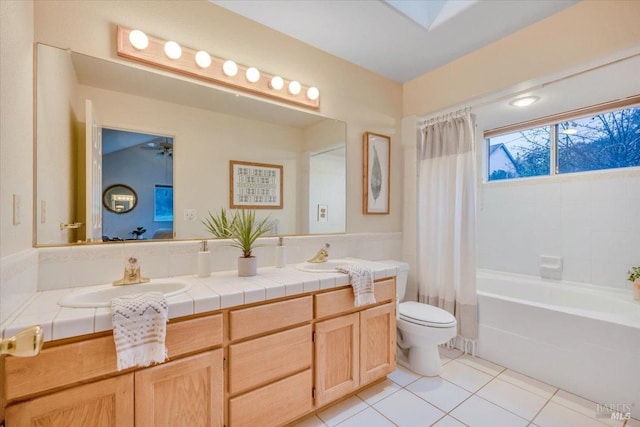 bathroom featuring toilet, vanity, and tile patterned floors