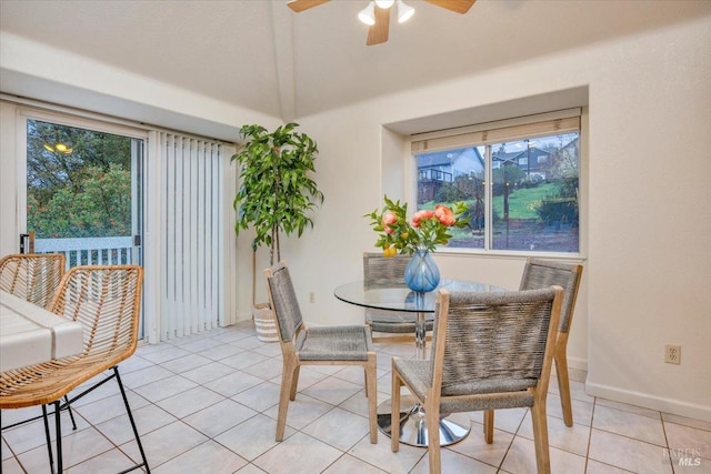 tiled dining space featuring ceiling fan