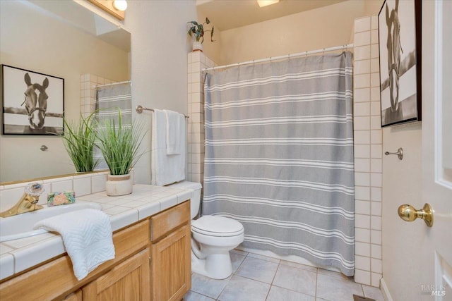 bathroom with toilet, vanity, tile patterned floors, and a shower with shower curtain