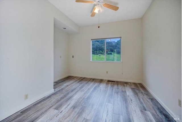 empty room with ceiling fan and light wood-type flooring