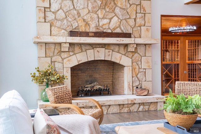 room details with a stone fireplace and wood-type flooring