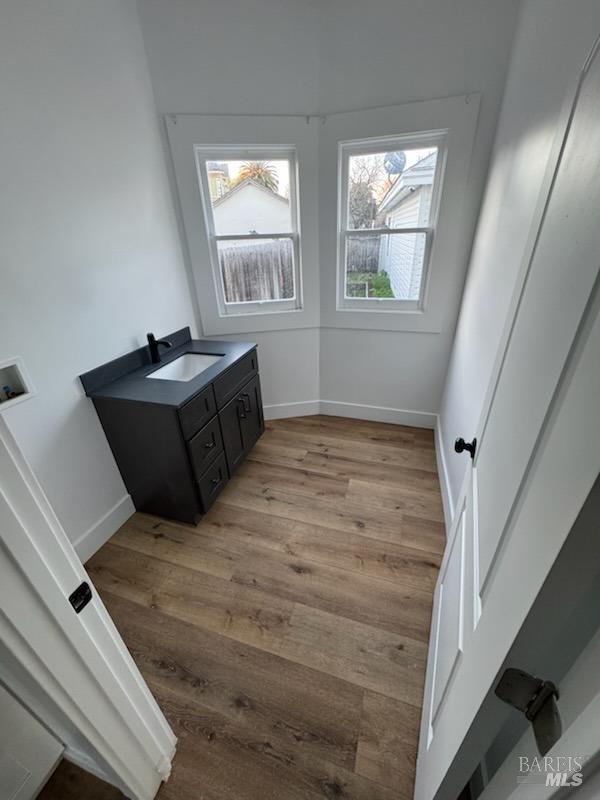 bathroom with vanity and hardwood / wood-style flooring