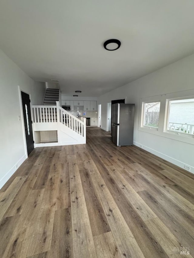 unfurnished living room featuring hardwood / wood-style flooring