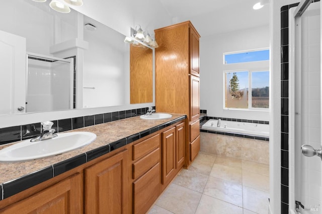 bathroom with tile patterned flooring, shower with separate bathtub, and vanity