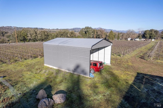 drone / aerial view featuring a mountain view and a rural view