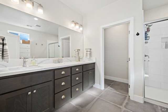 bathroom featuring a shower with door and vanity