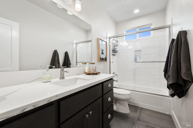 full bathroom featuring combined bath / shower with glass door, vanity, tile patterned floors, and toilet