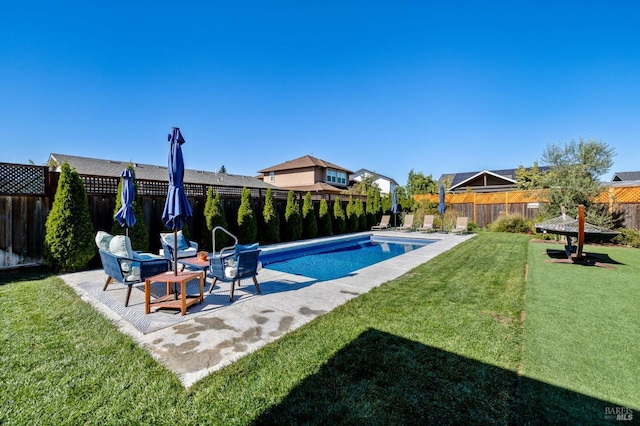 view of pool featuring a yard and a patio