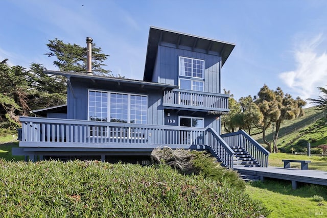 back of property featuring a wooden deck