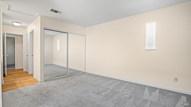 unfurnished bedroom featuring carpet floors and a closet