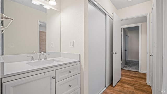 bathroom with hardwood / wood-style flooring and vanity