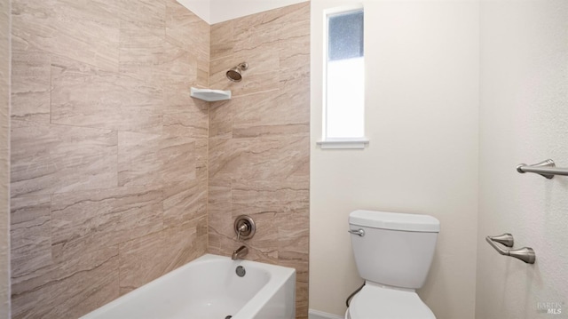 bathroom with toilet and tiled shower / bath combo