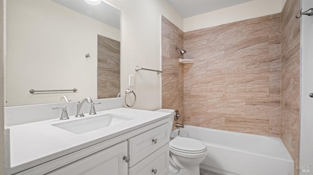 full bathroom with toilet, tiled shower / bath, and vanity