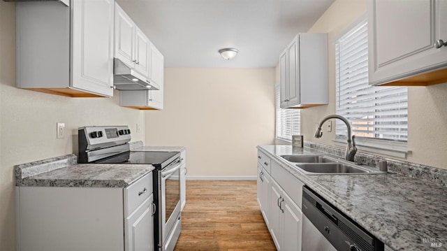 kitchen featuring light wood-type flooring, appliances with stainless steel finishes, white cabinetry, and sink