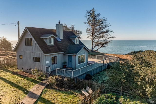 rear view of house featuring a water view, fence, a chimney, crawl space, and a yard