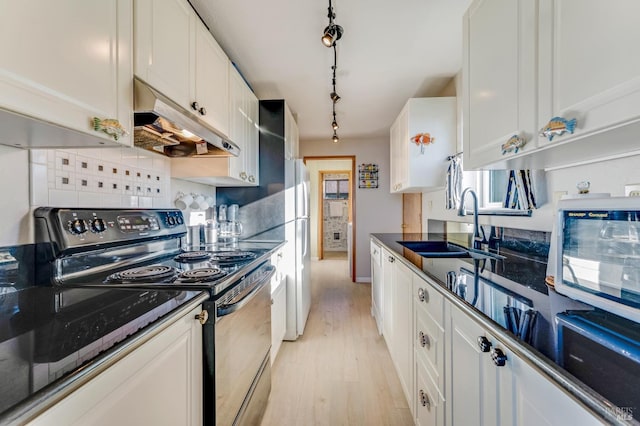 kitchen with white cabinets, black range with electric stovetop, tasteful backsplash, sink, and light wood-type flooring