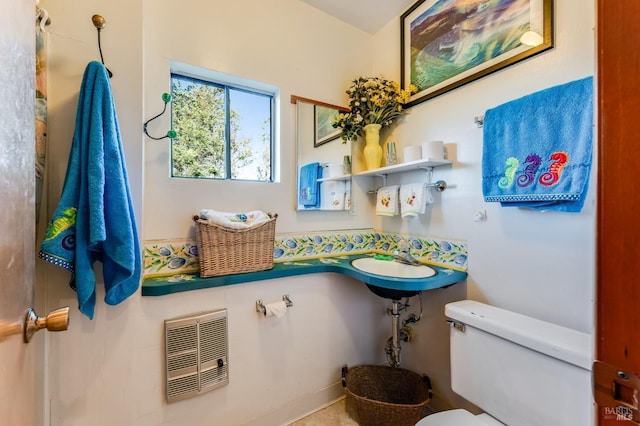 bathroom with toilet and heating unit