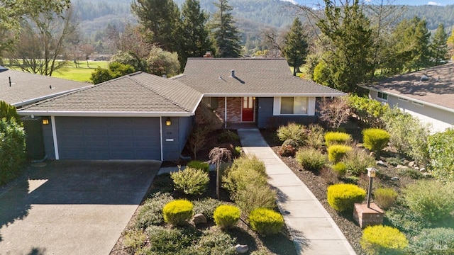 single story home featuring a garage and a mountain view