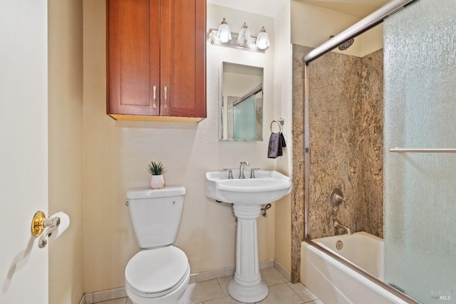 bathroom with bath / shower combo with glass door, toilet, and tile patterned flooring