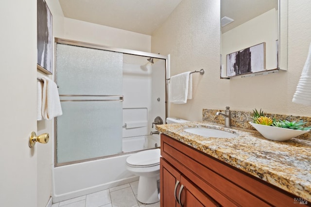 full bathroom with tile patterned floors, enclosed tub / shower combo, vanity, and toilet