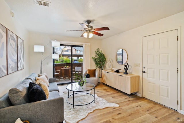 living room featuring ceiling fan and light wood-type flooring