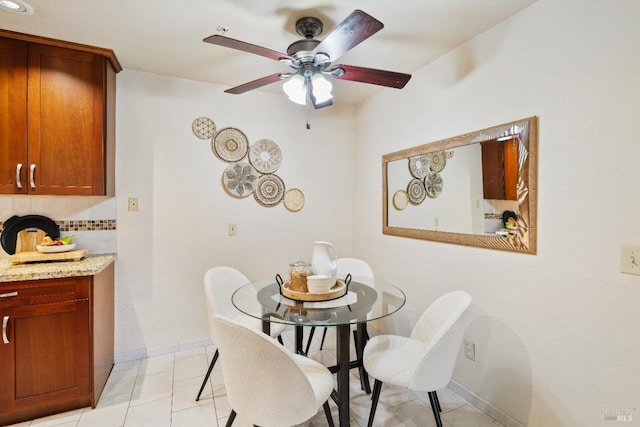 tiled dining room with ceiling fan