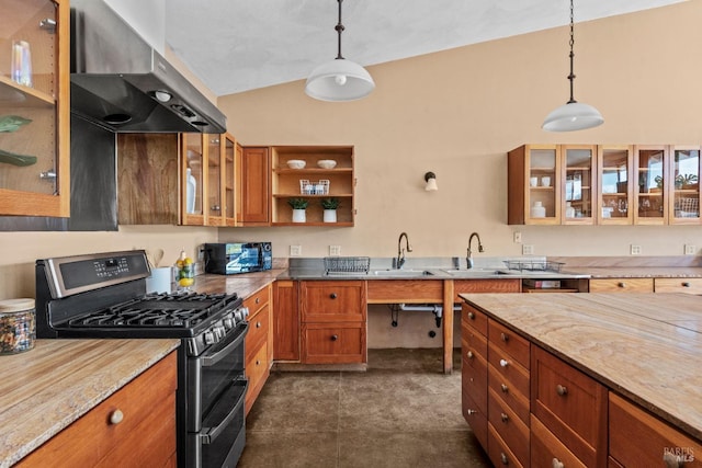 kitchen featuring wall chimney exhaust hood, lofted ceiling, light stone counters, decorative light fixtures, and double oven range