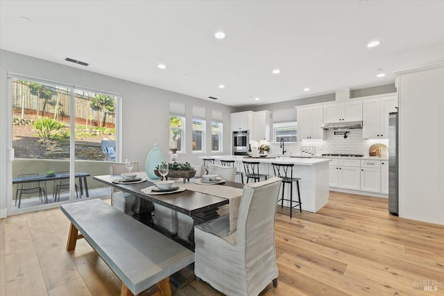 dining area with light hardwood / wood-style flooring