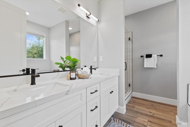 bathroom featuring vanity, hardwood / wood-style floors, and an enclosed shower