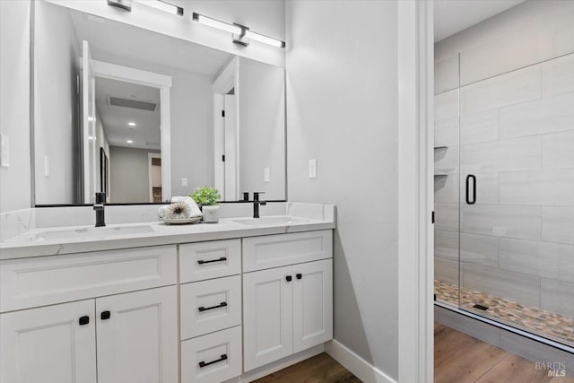 bathroom featuring vanity, a shower with shower door, and hardwood / wood-style floors