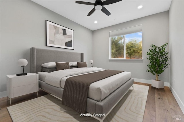 bedroom with ceiling fan and light hardwood / wood-style floors