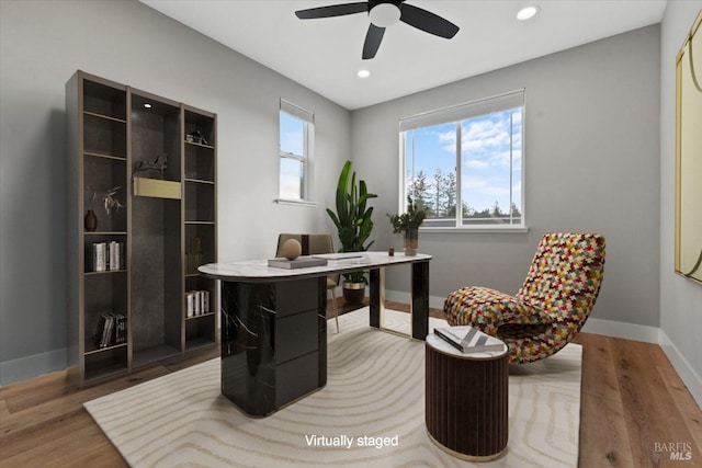 office featuring hardwood / wood-style floors and ceiling fan