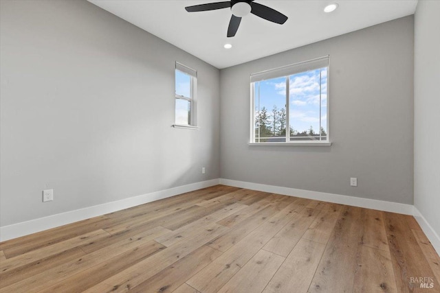 spare room with ceiling fan and light wood-type flooring