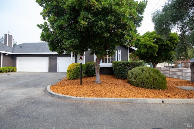 obstructed view of property with a garage