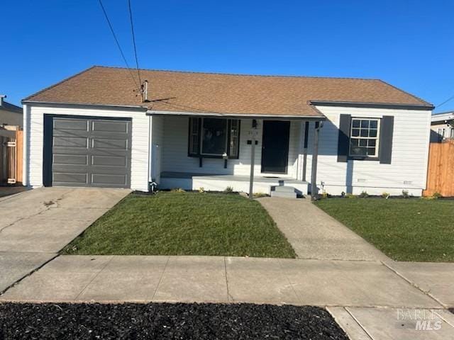 ranch-style house featuring a front lawn, covered porch, concrete driveway, an attached garage, and fence