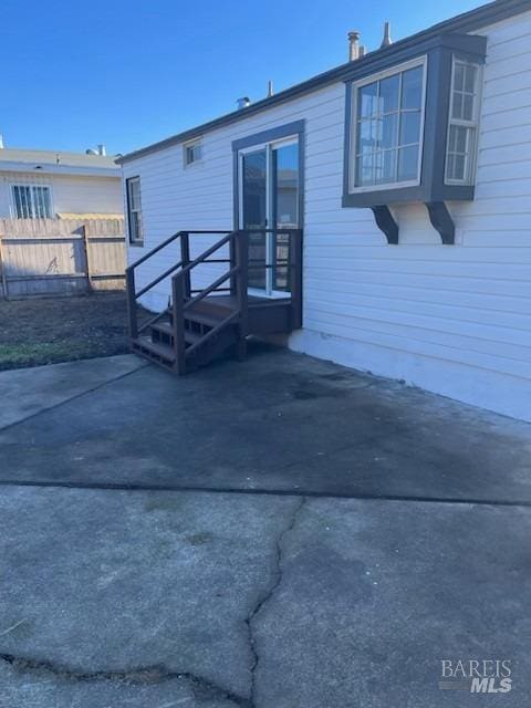 back of property with a patio and fence