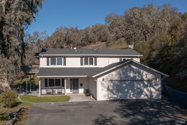 front facade with a garage and covered porch